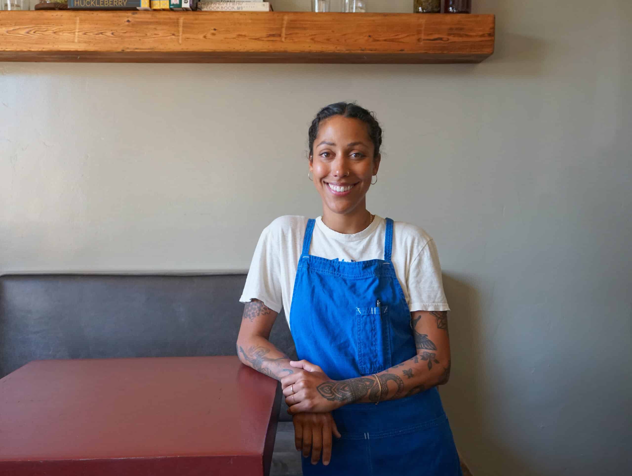 Executive Chef Zarah Khan leaning on a table in the bar